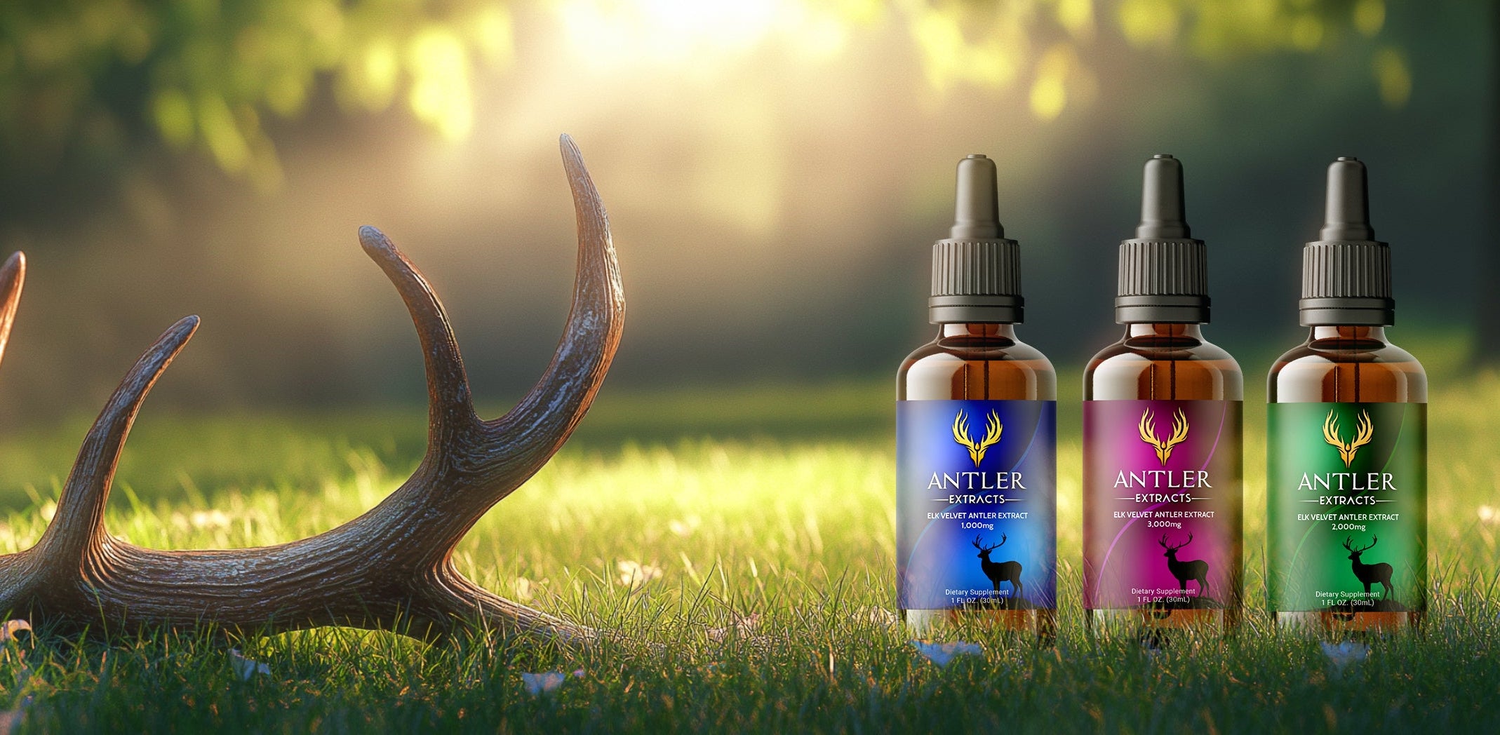 Three bottles of Antler supplement on grass with deer antlers and trees in the background

